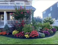 a house with flowers in the front yard