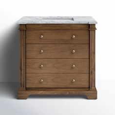 a wooden dresser with marble top and drawers on the bottom, against a white wall