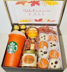 an open box containing coffee, cookies and candy