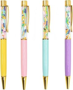 three different colored pens with gold trimmings on the ends and one has a flower design