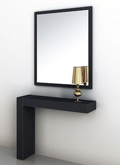 a black table with a mirror and two lamps on top of it in front of a white wall