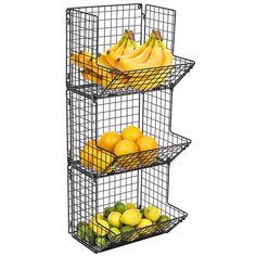 three wire baskets filled with fruit sitting on top of each other in front of a white background