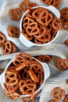 two bowls filled with pretzels on top of a table