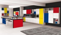 a modern kitchen with multicolored cabinets and black counter tops, an area rug on the floor