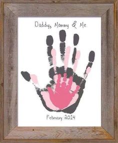 a handprint is displayed in a frame with the words daddy's mommy and me