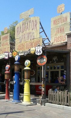 an old fashioned gas station with many signs on it