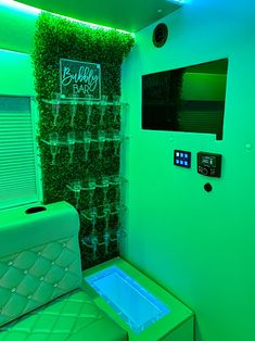 there is a green room with plants growing on the wall