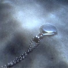 a close up view of a chain with a watch on it's end and the clasp