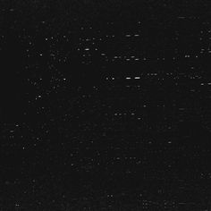 black and white image of the night sky with many small dots on it's surface