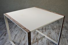 a white table sitting on top of a wooden floor