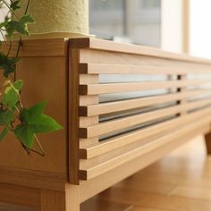 a close up of a wooden bench with a plant on it's back end