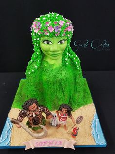 there is a cake made to look like a woman with green hair and flowers on her head