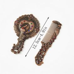 two antique style hair combs sitting next to each other