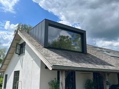 a white house with a black roof and windows