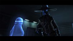 a man in a hat standing next to an alien