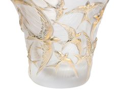 a glass vase with gold birds on it