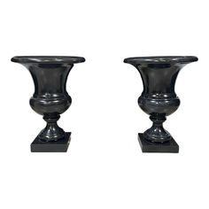 two black vases sitting on top of each other