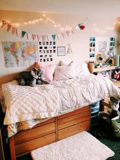 a bedroom with a bed, rugs and lights on the wall above it is decorated in white