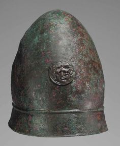 an old helmet is shown on a gray background