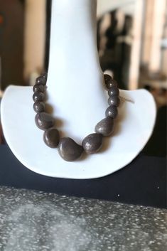 This head turning tagua necklace in pretty fall colors will be your favorite go-with-anything, day-to-night piece.  This fantastic handcrafted necklace makes a bold statement and is super versatile, and lightweight, it can be elegant or casual depending on your occasion. We designed this necklace with tagua nut beads and bombona seeds in charcoal gray.  Tagua, also called the vegetable ivory is the seed of a palm tree that grows in the tropical rainforests of several South American countries inc Olive Necklace, Organic Necklace, Resort Jewelry, Tagua Necklace, Orchid Necklace, Ivory Necklace, Seed Necklace, Rustic Necklace, Tagua Jewelry