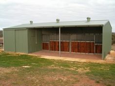 a large metal building with two stalls on each side