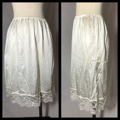 This is a white nylon half slip by Vassarette. Slip has wide lace trim. Approx. bottom of kneecap length. In good vintage condition with some marks near hem (see photos).  Size Large  Measurements  Waist unstretched 27" - full stretch 42" Hip 45" Length 24" Loc h/s/s/c Vintage White Lace Bottoms, White Lace Vintage Bottoms, White Vintage Lace Bottoms, Vintage Stretch Bottoms With Lace Trim, Vintage Style Stretch Bottoms With Lace Trim, Stretch Vintage Bottoms With Lace Trim, Trims Fashion, Fashion Bottoms, Half Slip