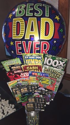 the best dad ever balloon is on display in a vase with candy and candies