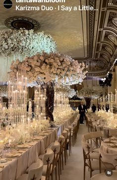 an image of a wedding reception with flowers and chandeliers