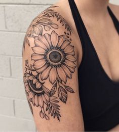 a woman with a sunflower tattoo on her arm