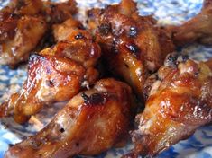 some chicken wings on a blue and white plate