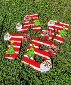 christmas themed lawn decorations in the shape of santa's stockings and trees on green grass