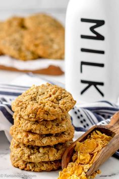 oatmeal cookies stacked on top of each other next to a bottle of milk