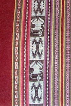 a close up of a red and white pillow with decorative designs on the front side