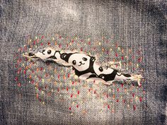 a pair of panda bears painted on the back of jeans