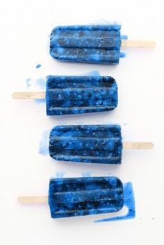 three popsicles with blue icing sitting on top of each other