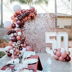 the table is set up with balloons and plates