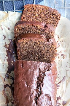 a loaf of chocolate cake sitting on top of a piece of paper