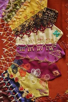 a close up of many different colored pieces of cloth