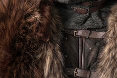 a close up view of a coat with fur on it