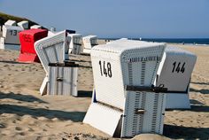 beach chairs with numbers on them sitting in the sand