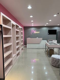 an empty room with white shelving and pink walls