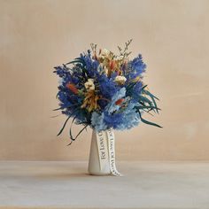 a vase filled with blue flowers on top of a table