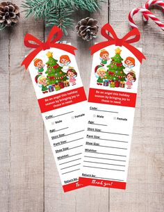 two christmas gift tags hanging from a wooden table with candy canes and pine cones