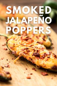 some food on a wooden cutting board with the words smoked jalapeno poppers