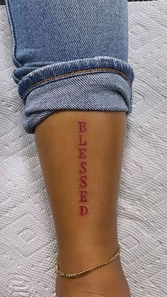 a person with a tattoo on their leg that says, pleased in red ink