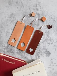 three leather bookmarks with hearts and stars on them