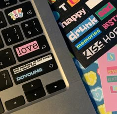 a laptop computer sitting on top of a table covered in stickers