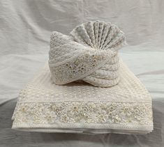 a white blanket with a decorative bow on it