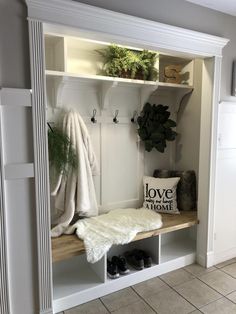 a white coat rack filled with plants and shoes