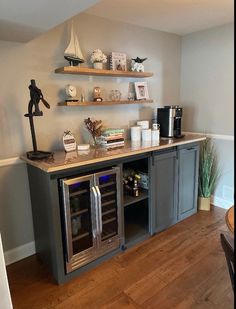 a kitchen area with shelves on the wall and a wine cooler in the corner next to it